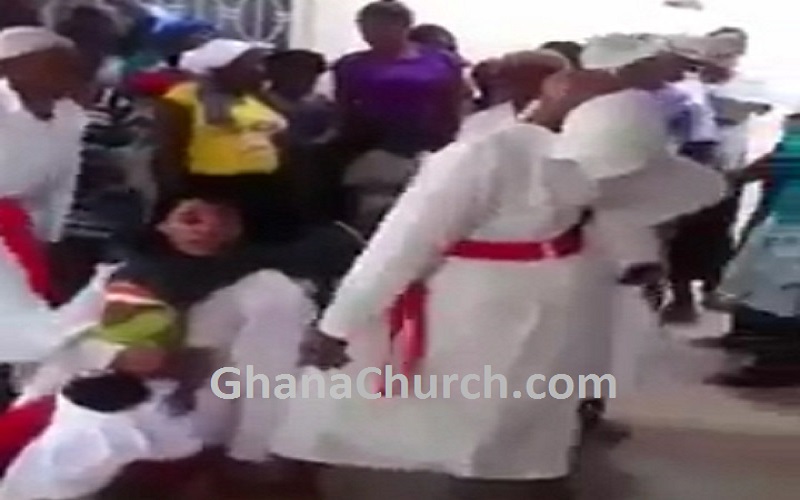 little toddler is swirled several times, thrown up and down, also held by the hair by the 'spiritual leader'.